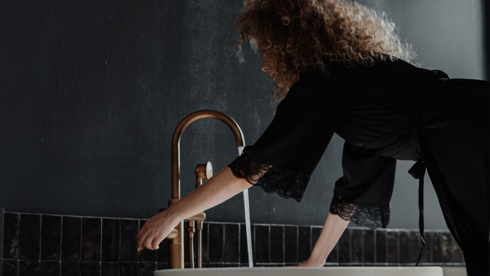 person running a bath in a luxury bathroom