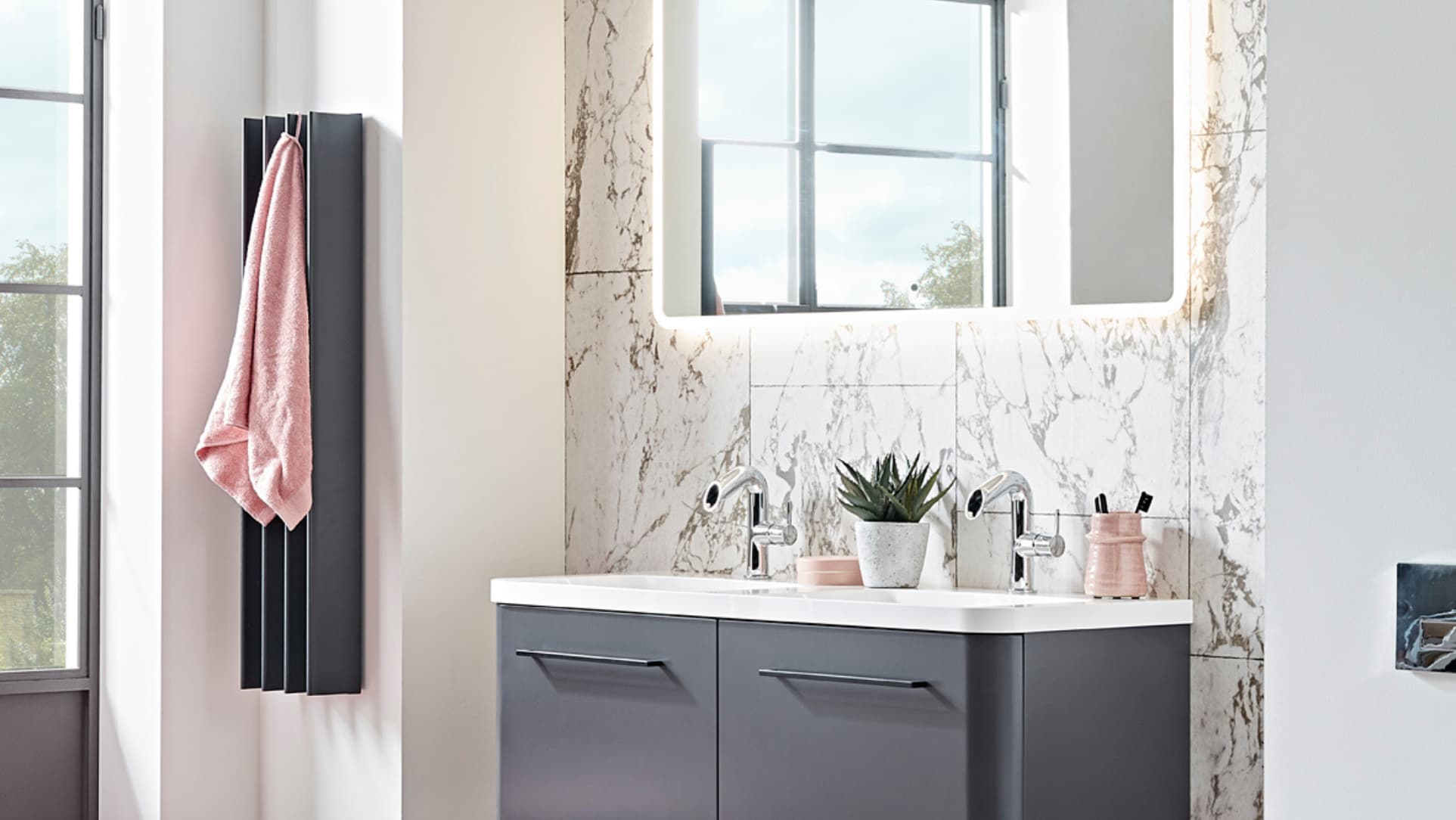 gordon heated towel rail dark grey sitting on a wall