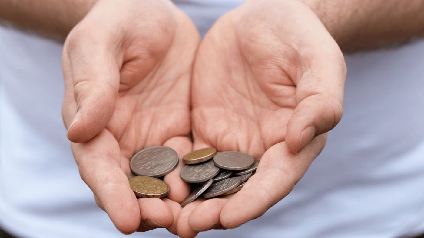 Man holding Australian coins in hand