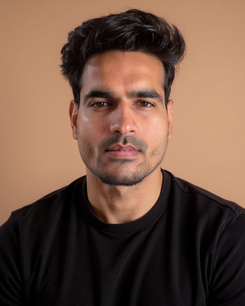 Man wearing a black shirt against a beige background
